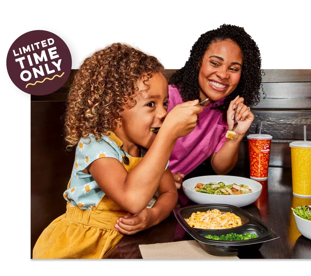 Limited Time Only. Kid eating a Noodles Kids Wisconsin Mac and Cheese with Broccoli next to her Mom enjoying a Zucchini Pesto with Grilled Chicken dish and a fountain drink.