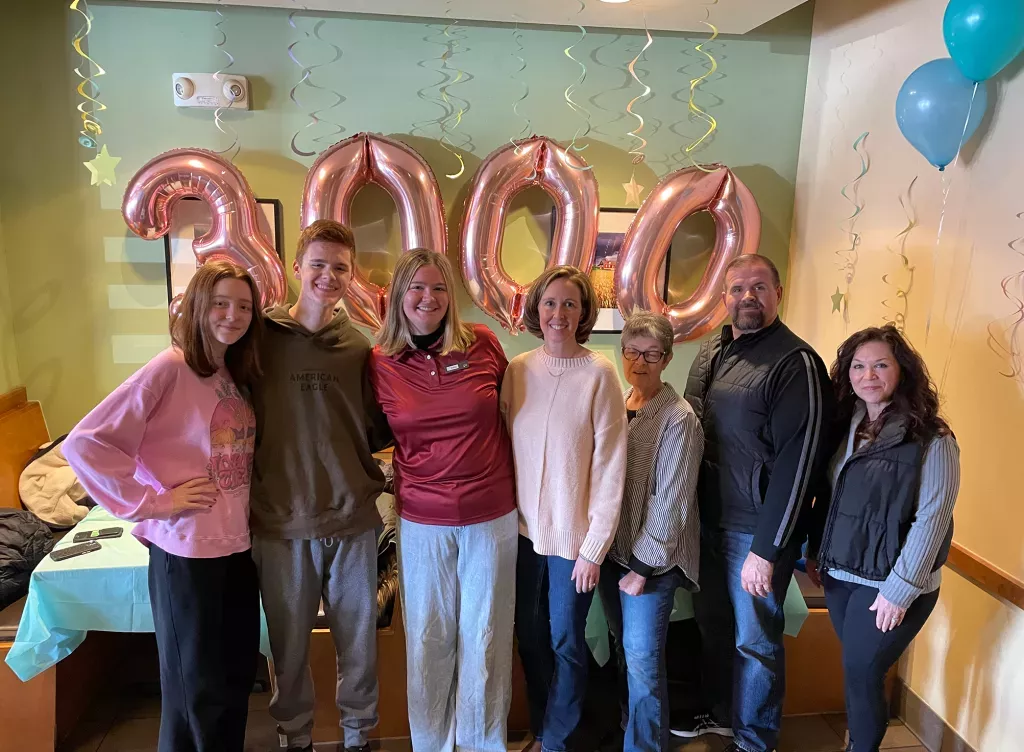 Noodles and Company 2025 Scholarship Award Winner surrounded by friends, family and fellow employees.