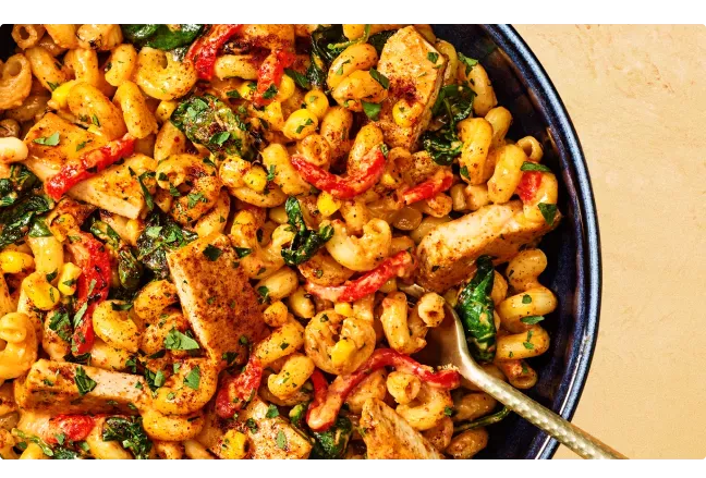 Noodles &amp; Company's Chipotle Chicken Cavatappi with gold spoon