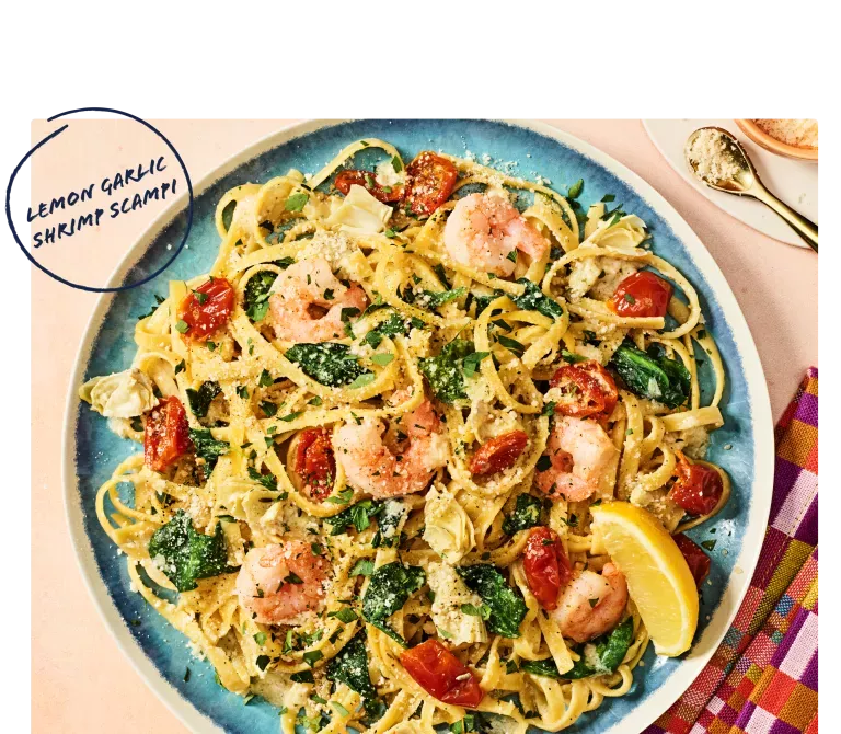 Noodles &amp; Company's Lemon Garlic Shrimp Scampi on blue plate with napkin