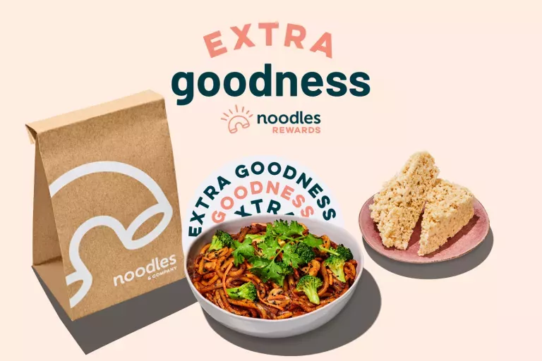 Extra goodness noodles rewards. Noodles delivery bag with a bowl of Japanese pan noodles and plate of two crispy desserts