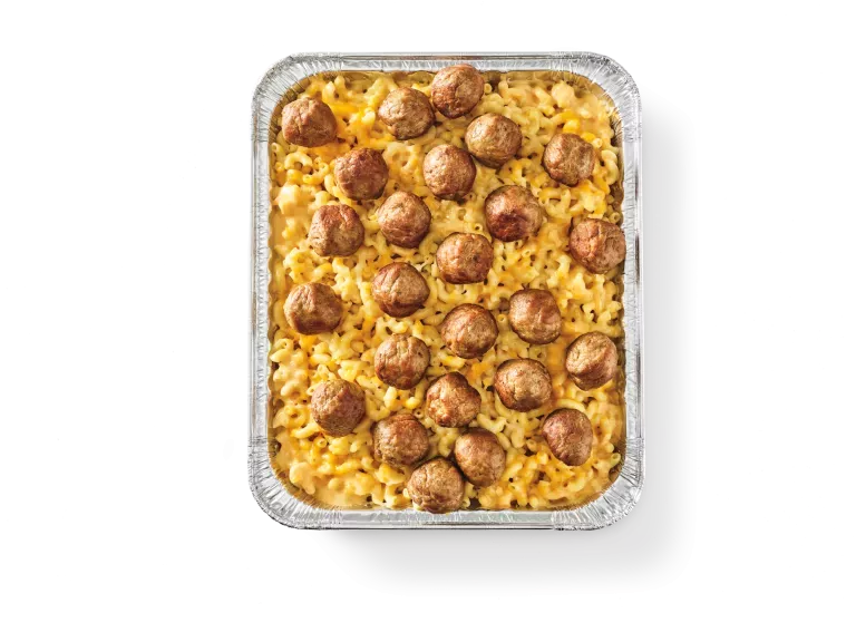 Pan of creamy cheddar mac and cheese with meatballs