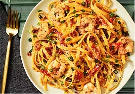 Tabletop image of Cajun shrimp fettuccine and a fork